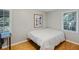 Bright bedroom with hardwood floors, two windows providing ample natural light, and neutral wall colors at 6275 Hunting Creek Rd, Atlanta, GA 30328