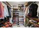 Walk-in closet featuring custom shelving, rods, and storage baskets for organized storage at 6275 Hunting Creek Rd, Atlanta, GA 30328