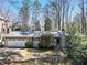 Charming home with a two-car garage and beautifully landscaped front yard and a brick chimney at 6275 Hunting Creek Rd, Atlanta, GA 30328