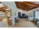 Open living room featuring hardwood floors, wood ceilings with skylights, and access to kitchen at 6275 Hunting Creek Rd, Atlanta, GA 30328