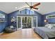 Bright main bedroom features a vaulted ceiling, wood floors, seating area, and French doors to outside deck at 6275 Hunting Creek Rd, Atlanta, GA 30328