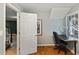 Home office/study with hardwood floors, natural light, and a view into the hallway and staircase at 6275 Hunting Creek Rd, Atlanta, GA 30328