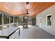 An outdoor screened-in porch with a wooden ceiling and floors, perfect for relaxing and entertaining at 6275 Hunting Creek Rd, Atlanta, GA 30328