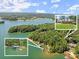 Stunning aerial view of a lakeside property featuring a home, docks, and lush greenery at 7565 Heard Rd, Cumming, GA 30041
