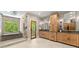 Elegant bathroom with wood vanities, a soaking tub, walk-in shower, and outdoor access to a balcony at 7565 Heard Rd, Cumming, GA 30041