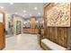 Spa-like bathroom retreat with dual vanities, a soaking tub, a walk-in shower, and a view of nature at 7565 Heard Rd, Cumming, GA 30041
