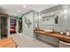 Bright bathroom with a modern vessel sink, wooden counter, unique lighting, and adjacent sauna at 7565 Heard Rd, Cumming, GA 30041
