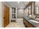 Modern bathroom with dual sinks, stone tile shower and floors and custom wood cabinets at 7565 Heard Rd, Cumming, GA 30041