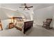Comfortable bedroom featuring neutral colors, a large bed, a ceiling fan and natural light at 7565 Heard Rd, Cumming, GA 30041