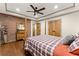 Bedroom boasts hardwood floors, a queen bed, exposed brick, and tray ceiling at 7565 Heard Rd, Cumming, GA 30041