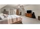 Large carpeted bedroom featuring a window, closet, a warm and inviting atmosphere at 7565 Heard Rd, Cumming, GA 30041