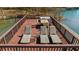 Relaxing dock deck features lounge chairs and table, perfect for enjoying lake views and outdoor relaxation at 7565 Heard Rd, Cumming, GA 30041