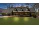 Charming one-story home with three dormers and a well-manicured lawn leading to a covered front porch at 7565 Heard Rd, Cumming, GA 30041