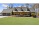 Charming one-story home with three dormers and a well-manicured lawn leading to a covered front porch at 7565 Heard Rd, Cumming, GA 30041