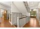 Spacious foyer with hardwood floors, paneled walls, stairway, and front doors with glass windows at 7565 Heard Rd, Cumming, GA 30041