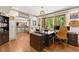 Bright home office with large windows, desk, and a view of the wooded outdoors at 7565 Heard Rd, Cumming, GA 30041
