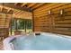 Relaxing hot tub on a covered patio with a wooded view, perfect for unwinding at 7565 Heard Rd, Cumming, GA 30041