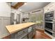 Traditional kitchen with a butcher block island, stainless steel appliances, and custom cabinetry at 7565 Heard Rd, Cumming, GA 30041