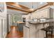 Kitchen featuring an island, granite countertops, stainless steel appliances, and wood beam ceilings at 7565 Heard Rd, Cumming, GA 30041