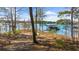 Scenic lake view with a boat dock and a winding path through trees leading to the water's edge at 7565 Heard Rd, Cumming, GA 30041