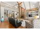 Open-concept living room featuring a fireplace, hardwood floors, built-in shelving, and ample seating at 7565 Heard Rd, Cumming, GA 30041