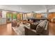 Open living room featuring hardwood floors, comfortable seating, game table, and access to the outdoors at 7565 Heard Rd, Cumming, GA 30041