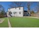A well-maintained backyard with a large lawn and a two-story house in the background at 1630 Sylvan Sw Rd, Atlanta, GA 30310