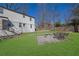 A backyard featuring a stone fire pit and seating, ideal for gatherings and relaxation at 1630 Sylvan Sw Rd, Atlanta, GA 30310