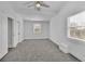 Spacious, well-lit bedroom with a ceiling fan and two windows at 1630 Sylvan Sw Rd, Atlanta, GA 30310