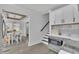 Open concept dining area with modern lighting and an adjacent staircase at 1630 Sylvan Sw Rd, Atlanta, GA 30310