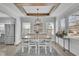 Charming dining room featuring a modern chandelier, wood beams, and abundant natural light at 1630 Sylvan Sw Rd, Atlanta, GA 30310