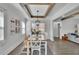 Elegant dining room with a modern light fixture, wood beams, and an open layout at 1630 Sylvan Sw Rd, Atlanta, GA 30310