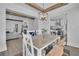Stylish dining room featuring wooden beams and a view into the living room and kitchen at 1630 Sylvan Sw Rd, Atlanta, GA 30310