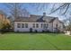 Charming home featuring a lush green lawn and neatly manicured landscaping at 1630 Sylvan Sw Rd, Atlanta, GA 30310