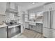 Bright kitchen featuring stainless steel appliances, modern white cabinets, and stylish countertops at 1630 Sylvan Sw Rd, Atlanta, GA 30310