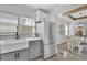 Well-lit kitchen featuring stainless steel appliances, grey cabinets, and a large farmhouse sink at 1630 Sylvan Sw Rd, Atlanta, GA 30310