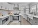 Modern kitchen with white subway tiles, stainless steel appliances, and gray lower cabinets at 1630 Sylvan Sw Rd, Atlanta, GA 30310