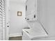 Efficient laundry area with a stacked washer and dryer unit and ample storage space at 1630 Sylvan Sw Rd, Atlanta, GA 30310