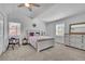 Bright and airy main bedroom with neutral colors and a decorative ceiling fan at 1630 Sylvan Sw Rd, Atlanta, GA 30310