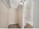 Walk-in closet with a view of the bathroom featuring a walk-in shower, new granite vanity, and tile flooring at 542 Oak Hills Sw Rd, Mableton, GA 30126