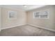 Cozy bedroom with plush carpet, two windows, and neutral paint, creating a serene atmosphere at 542 Oak Hills Sw Rd, Mableton, GA 30126