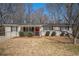 Charming single-story home featuring a well-maintained lawn and a vibrant red front door at 542 Oak Hills Sw Rd, Mableton, GA 30126