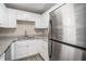Kitchen featuring stainless steel refrigerator, granite countertops, and white cabinets at 542 Oak Hills Sw Rd, Mableton, GA 30126
