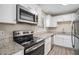 Kitchen with granite countertops, stainless steel appliances, and white cabinets at 542 Oak Hills Sw Rd, Mableton, GA 30126