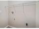 Simple laundry room features washer hook-ups and a white rack for storage, all set against neutral walls at 542 Oak Hills Sw Rd, Mableton, GA 30126