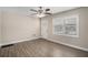 Bright living room with wood-look flooring, ceiling fan and lots of natural light from the window at 542 Oak Hills Sw Rd, Mableton, GA 30126