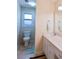 Bathroom featuring vanity with a large mirror and toilet at 566 Sugar Valley Lane, Conyers, GA 30094