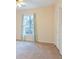 A bedroom featuring neutral walls, carpet floors, and a window with curtains at 566 Sugar Valley Lane, Conyers, GA 30094