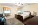 Comfortable bedroom with a ceiling fan, carpet and large window at 566 Sugar Valley Lane, Conyers, GA 30094
