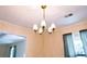 Elegant dining room with decorative chandelier, large windows, and neutral wall color at 566 Sugar Valley Lane, Conyers, GA 30094